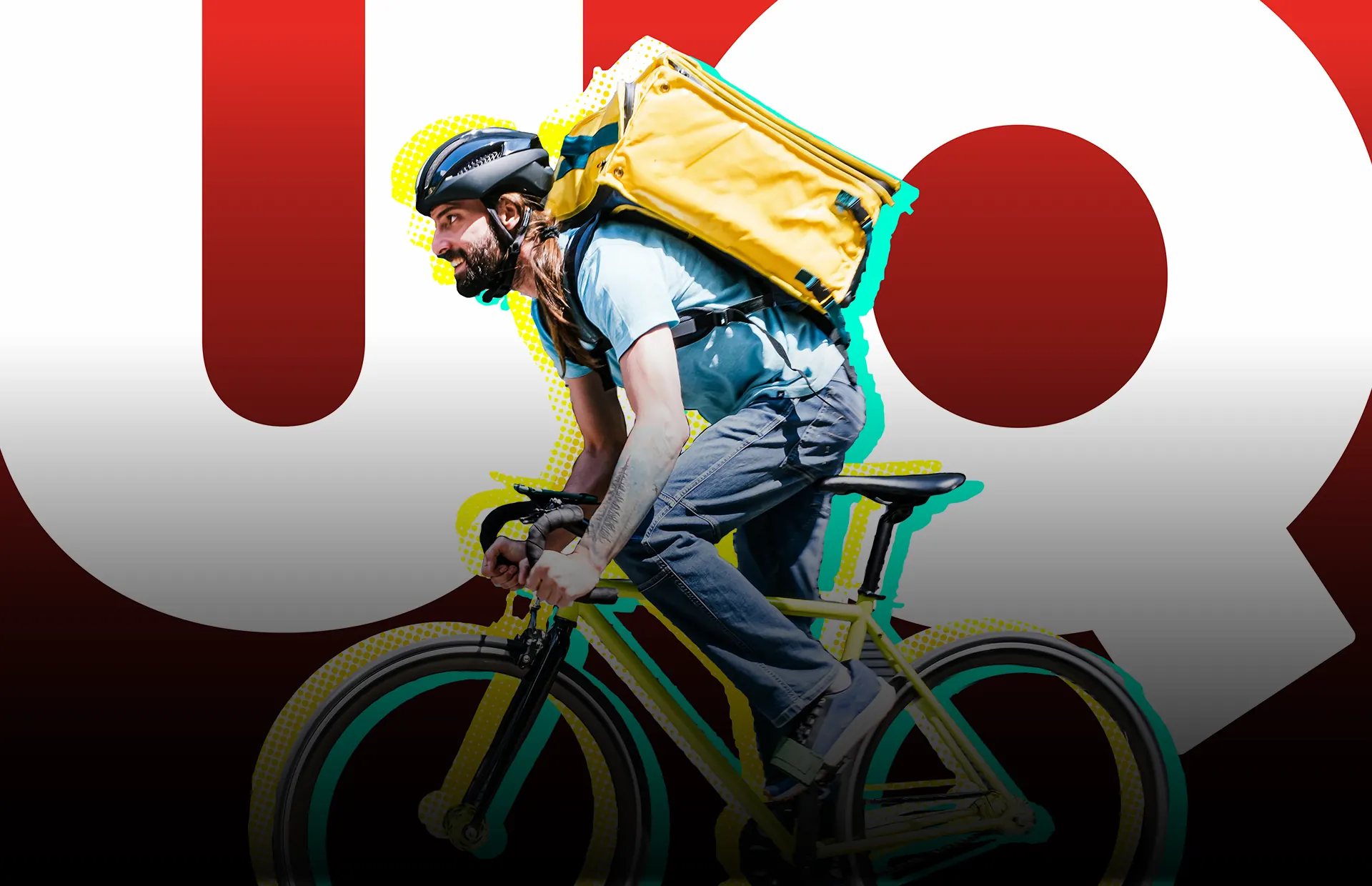 A bike courier rides past giant UQ letters.